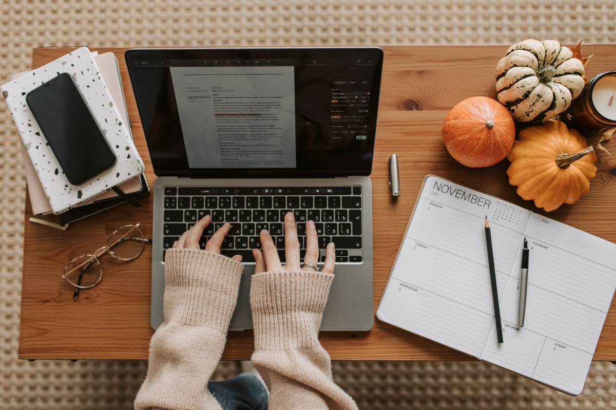 Woman typing her marketing plan and considering whether to run ads for her school